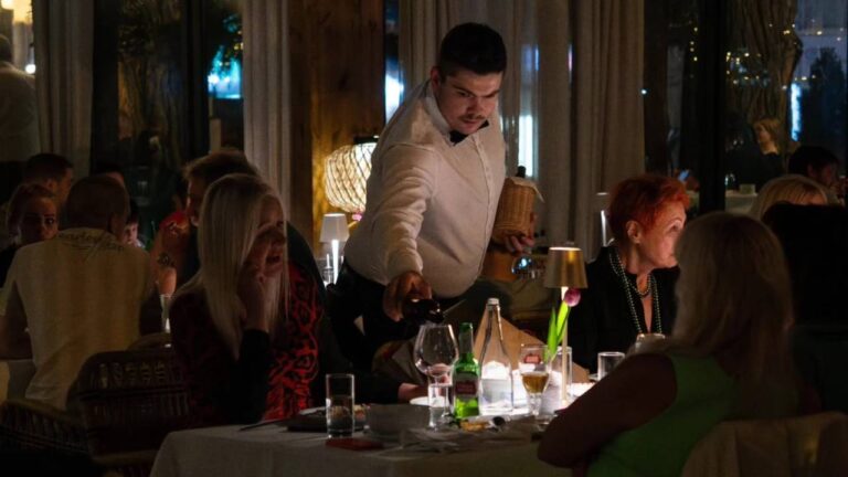 Waiter serving food in restaurant in Skadarlija